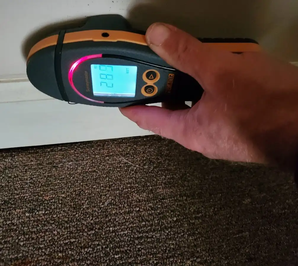 Moisture detection at baseboard during Storm Damage Restoration in Carthage